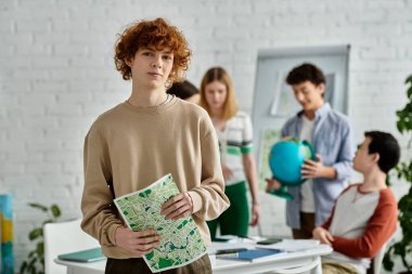 A teenager stands holding a map during a United Nations model simulation. clipart