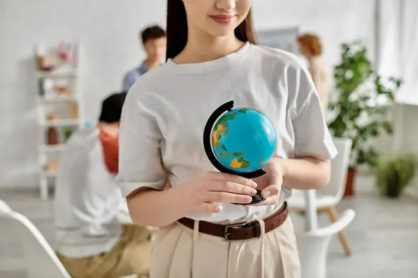 stock image A teenage girl holds a globe during a UN Model conference.