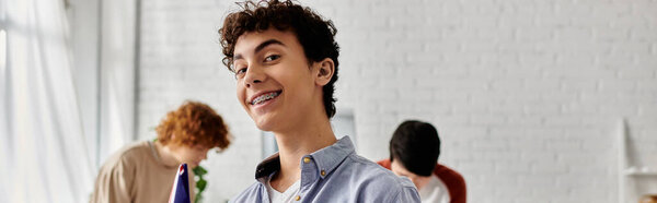 Teenage boy smiles while participating in a UN Model conference.