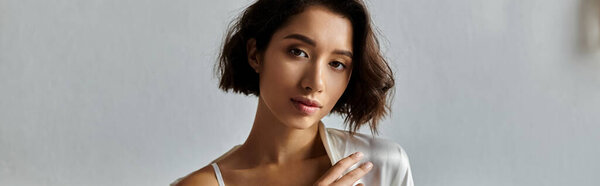 A young Asian woman in a white robe and underwear