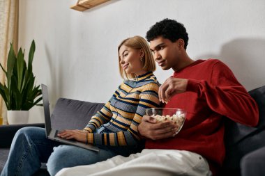Mutlu, çok kültürlü bir çift, rahat ve modern dairelerinde film gecesinin tadını çıkarıyor..