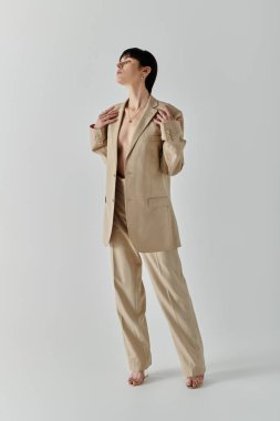 A woman in a tan suit poses against a white background. clipart