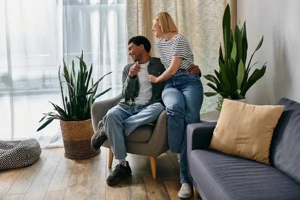 stock image A young interracial couple enjoys a relaxing afternoon together in their modern apartment.