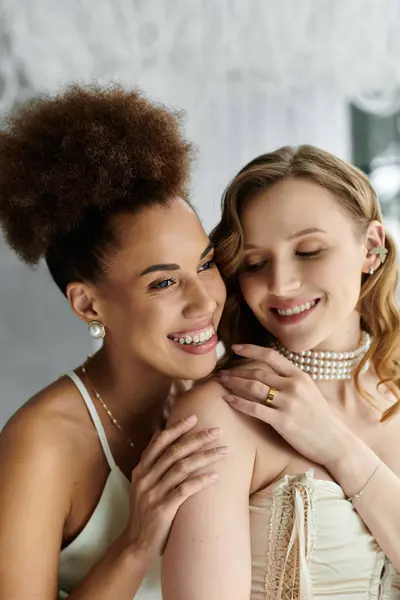 stock image Two brides, one with a curly hair, embrace on their wedding day.