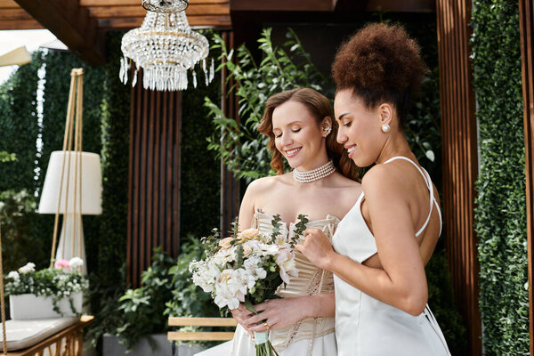 Two brides share a loving moment during their wedding ceremony.
