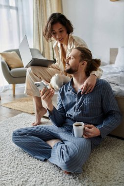 A couple relaxes at home, enjoying each others company. clipart