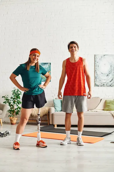 stock image Woman with prosthetic, boyfriend pose in living room during workout.