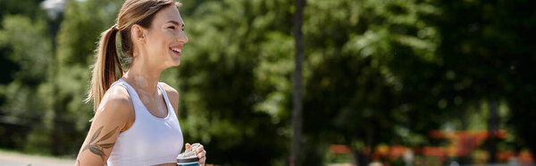 A young woman with vitiligo runs through a park, smiling at the camera, her ponytail bouncing.