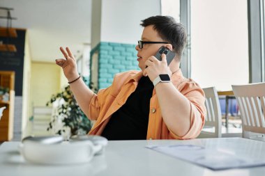 A man with Down syndrome makes ordering while he is having the phone call clipart