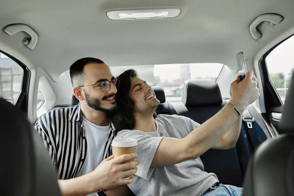 stock image A gay couple takes a selfie in the backseat of a car, enjoying their time together.