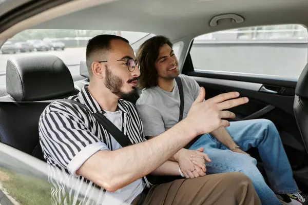 stock image Two men, a gay couple, share a lighthearted moment together in a car.