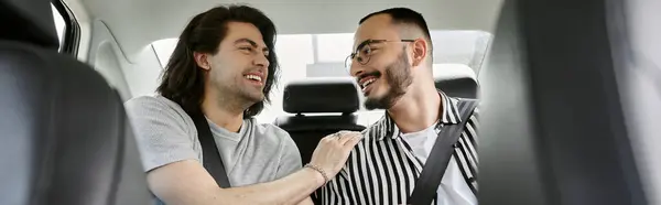 stock image Two men laugh together in the backseat of a car, enjoying a moment of shared joy.