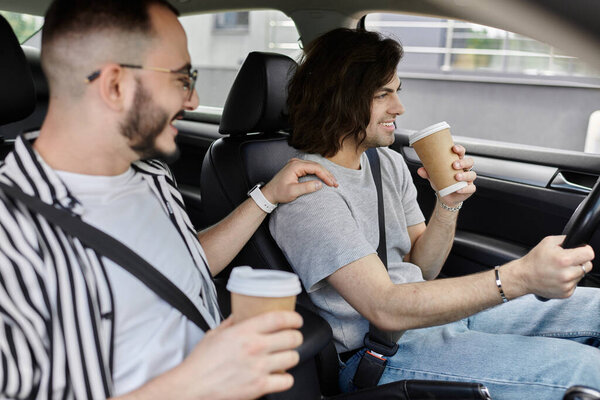 A gay couple shares a moment of intimacy and laughter while enjoying a coffee run.
