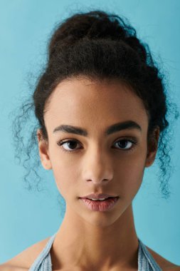 A young woman with curly hair gazes directly at the camera with a confident expression. clipart