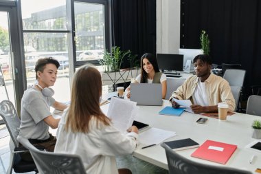Genç profesyonellerden oluşan çeşitli bir ekip bir girişim projesinde işbirliği yapıyor