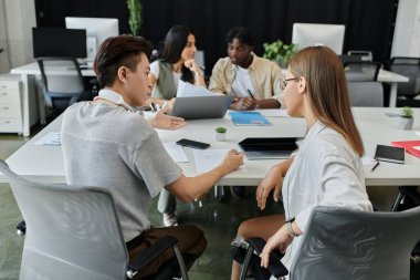 Young pros meet in modern office, brainstorming ideas clipart