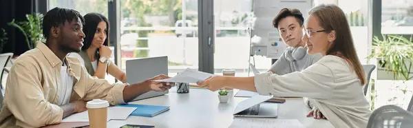 stock image Four colleagues discuss business plans in a modern office.