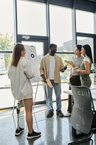 stock image A diverse group of colleagues collaborates in a contemporary office setting.