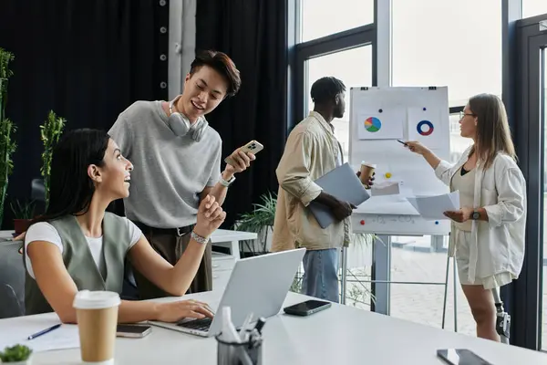 stock image A diverse team works on a startup project, analyzing charts and discussing ideas.