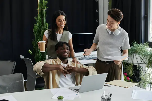 stock image Three colleagues work together on a project, beaming with excitement and pride