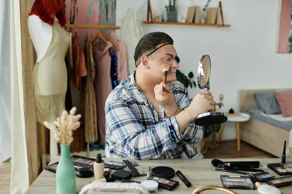 Eşcinsel bir insan, çeşitli güzellik ürünleriyle çevrili bir aynanın önünde makyaj yapar..