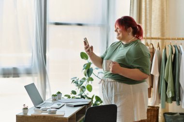 A happy woman enjoys a morning coffee while checking her phone. clipart