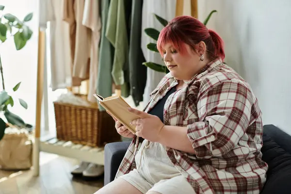 stock image A woman relaxes in her home, engrossed in a book.