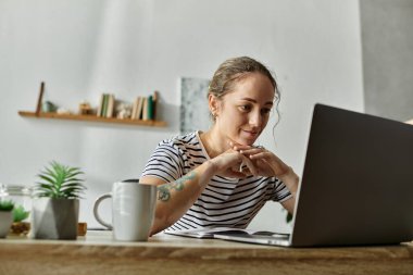 Vitiligo 'su olan bir kadın evde dizüstü bilgisayarla çalışmaktan zevk alıyor..