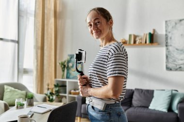 A joyful woman with vitiligo poses confidently with her camera. clipart