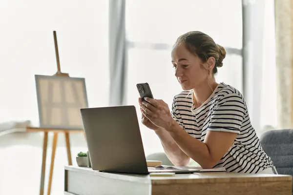 stock image A joyful woman with vitiligo explores creativity on her mobile device.