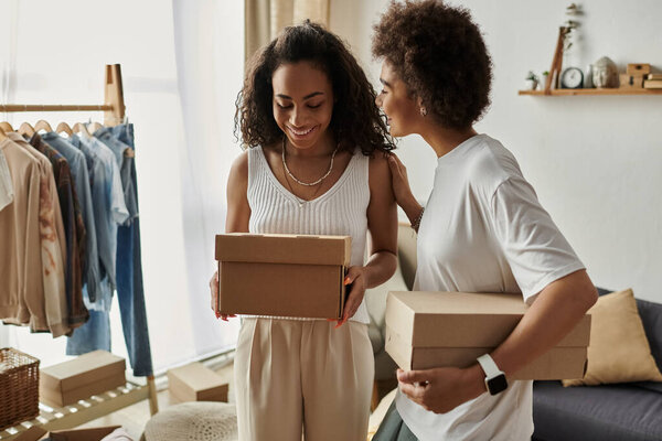 A joyful couple revitalizes their wardrobe with upcycled clothing, holding boxes.
