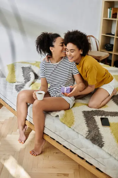 Stock image Two partners share laughter and love over morning coffee and treats at home.