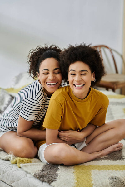 A loving couple shares laughter and warmth on a sunny day indoors.