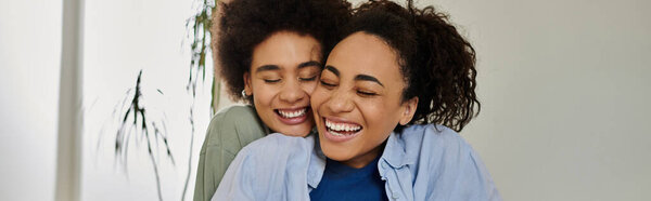 Two women share a warm embrace, radiating happiness in their cozy home.