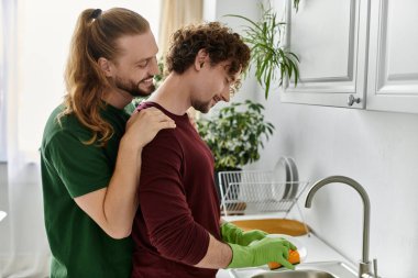 Two partners share a tender moment while preparing a meal. clipart