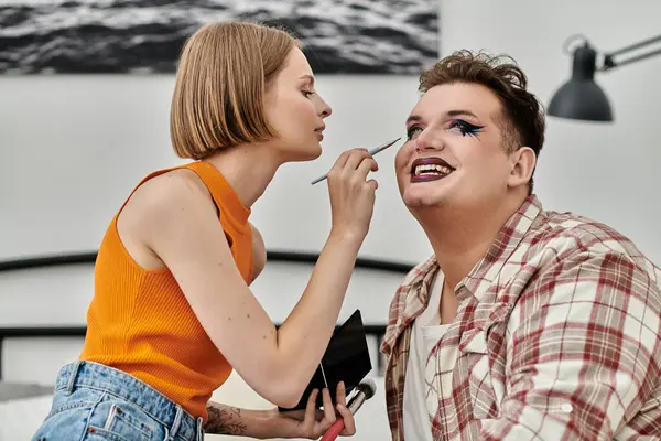 stock image A stylish person gets their makeup done by a friend in a cozy atmosphere.