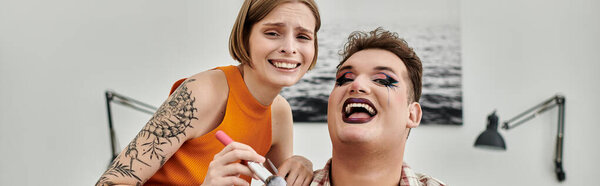 Friends share laughter and creativity during a fun makeup session indoors.