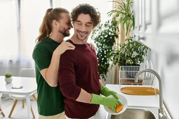 stock image Two partners share a joyful moment while cleaning up in their cozy home.