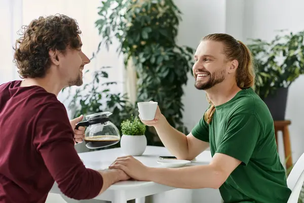 stock image A happy couple shares a moment over coffee, smiling and enjoying each other.