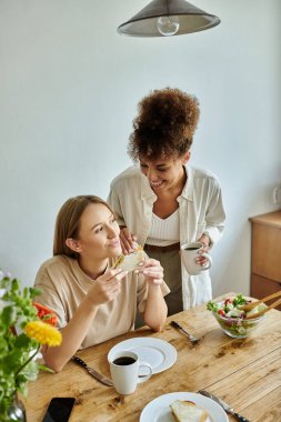 Sevgi dolu bir çift kahvaltıdan zevk alır, gülümsemelerini ve lezzetli yemeklerini paylaşırlar..