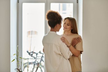 A lovely couple shares a warm embrace indoors, radiating love and happiness. clipart