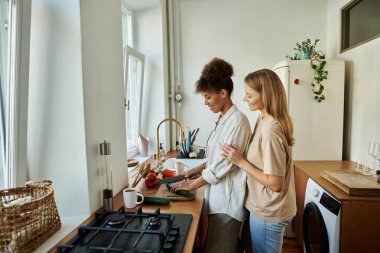 Sevgili çift birlikte yemek hazırlar, neşe ve bağ anlarını paylaşır..