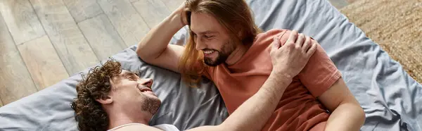 stock image A joyful couple relaxes on the floor, sharing laughter and affection indoors.