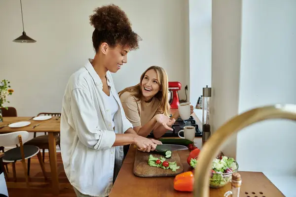 stock image A joyful couple shares laughter while preparing a meal together.