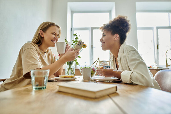 Two happy partners enjoy a joyful moment over coffee and dessert.