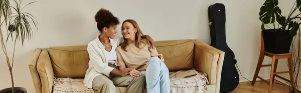 stock image A cheerful couple enjoys quality time on their cozy sofa.