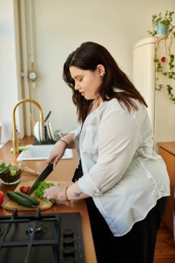 A woman prepares fresh veggies at home, embracing culinary creativity and joy. clipart