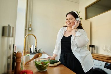 Kadınlar modern mutfağında gülümserken canlı bir salata hazırlamaktan hoşlanırlar..