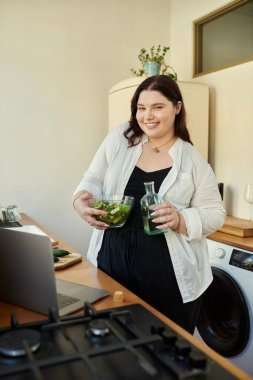 A woman joyfully prepares fresh greens in her inviting kitchen space. clipart