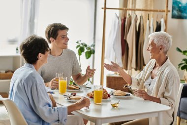 A warm and lively breakfast where a family shares laughter and delicious food together. clipart